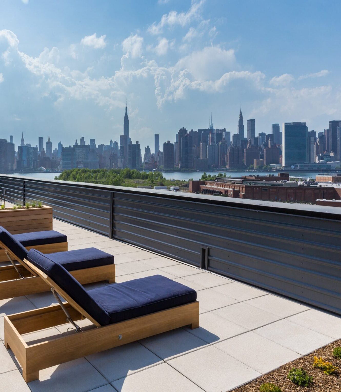 Deck with cushioned lounge seating and skyline views