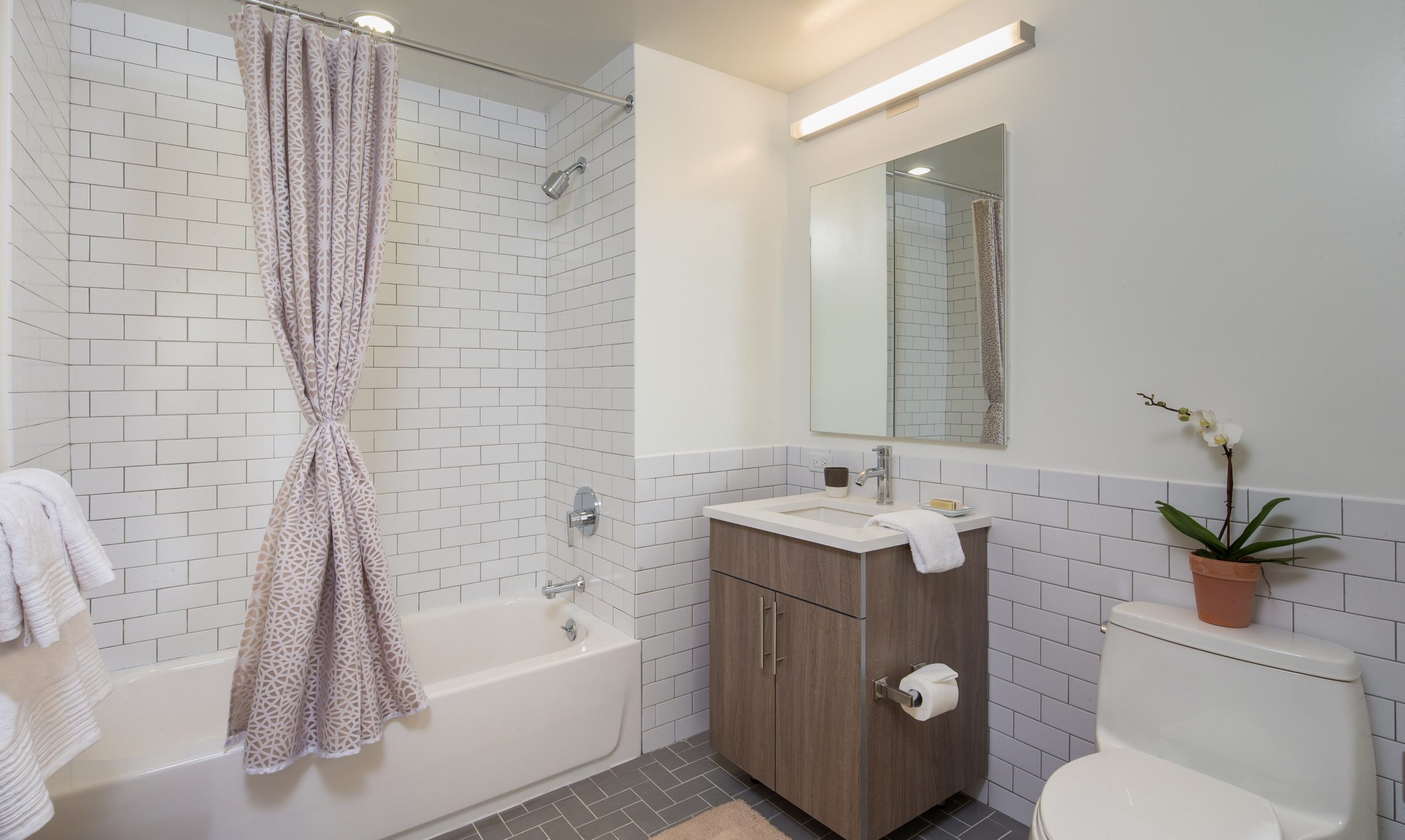 Bathroom with subway tiled shower and walls